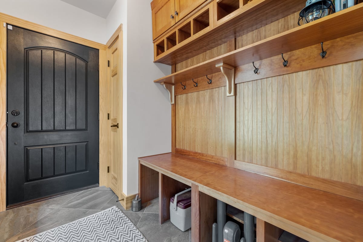 Mudroom with wooden bench and coat rack