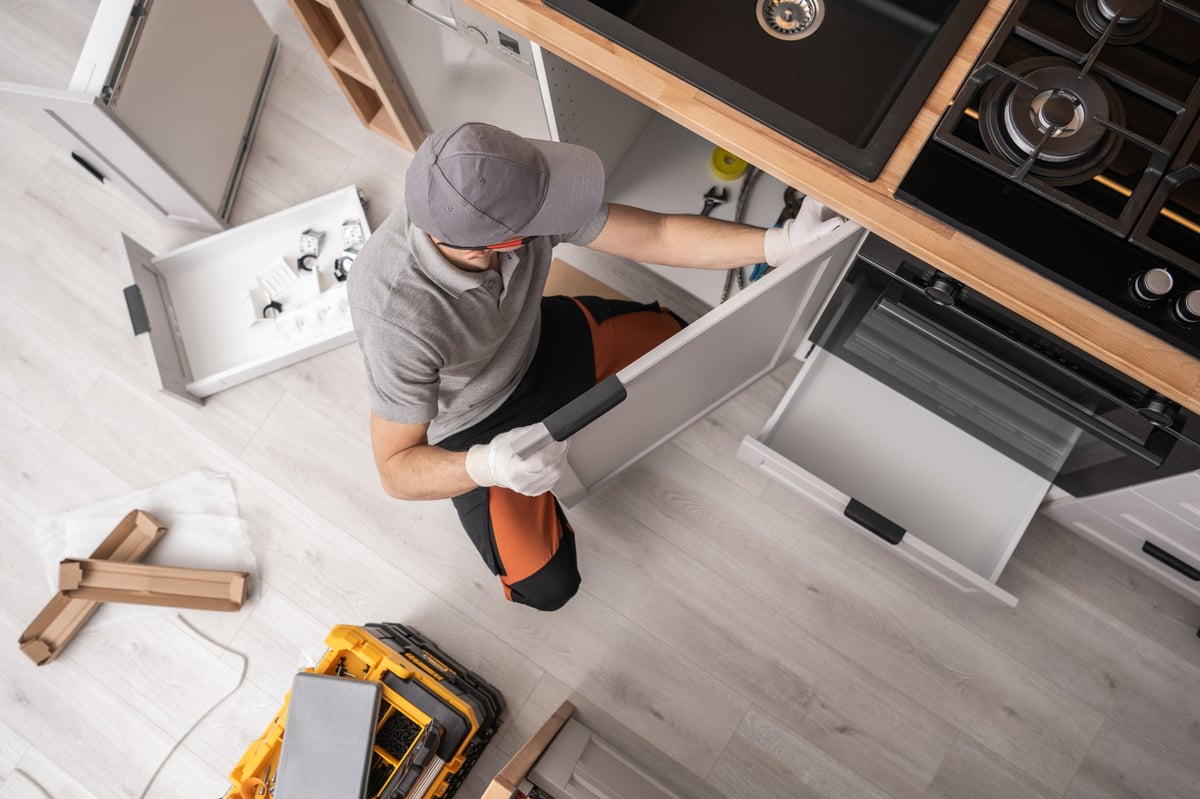 Professional cabinetmaker installing furniture