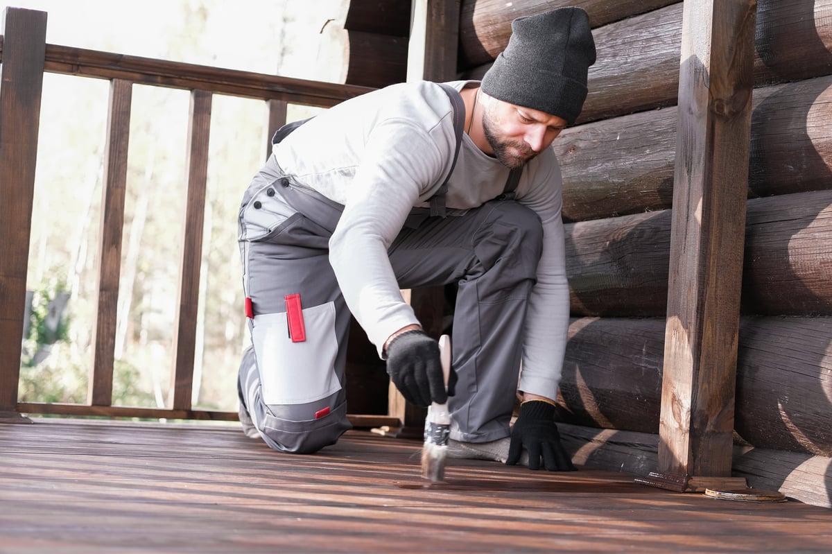 Woodworker applying finish to wood surface
